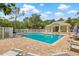 Community pool area featuring a spacious pool, lounge chairs, and a clubhouse for relaxation at 476 Santa Cruz Ne Pl # C, St Petersburg, FL 33703