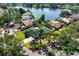 Aerial view of a home with a pool, a well-manicured lawn, and nearby lake at 500 Tallahassee Ne Dr, St Petersburg, FL 33702