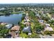 Aerial view of property overlooking a picturesque lake, pool, and well-manicured grounds at 500 Tallahassee Ne Dr, St Petersburg, FL 33702