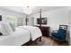 Bright bedroom featuring a four-poster bed, flat screen tv, and hardwood floors at 500 Tallahassee Ne Dr, St Petersburg, FL 33702
