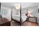 Bright bedroom featuring a four-poster bed, decorative chandelier, and hardwood floors at 500 Tallahassee Ne Dr, St Petersburg, FL 33702