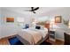 Well-lit bedroom features hardwood floors, a ceiling fan, and two sunny windows at 500 Tallahassee Ne Dr, St Petersburg, FL 33702