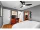 Comfortable bedroom with light wood floors, ceiling fan, dresser, and a closet at 500 Tallahassee Ne Dr, St Petersburg, FL 33702