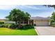 Charming single-story home featuring a well-manicured lawn, mature landscaping, and a brick driveway at 500 Tallahassee Ne Dr, St Petersburg, FL 33702