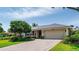 Charming single-story home featuring a well-manicured lawn, mature landscaping, and a brick driveway at 500 Tallahassee Ne Dr, St Petersburg, FL 33702