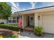 Charming front porch with decorative door, beautiful flag, and lush landscaping at 500 Tallahassee Ne Dr, St Petersburg, FL 33702