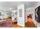 Bright hallway with wood floors leading to the living areas, featuring stylish decor and ample lighting at 500 Tallahassee Ne Dr, St Petersburg, FL 33702
