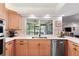 Bright kitchen boasting light wood cabinets, stainless appliances, and a view of the pool at 500 Tallahassee Ne Dr, St Petersburg, FL 33702