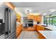 Well-lit kitchen with stainless steel appliances, wooden cabinets, and quartz countertops and with eat-in dining area at 500 Tallahassee Ne Dr, St Petersburg, FL 33702