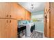 Well-lit laundry room with front load washer and dryer, and ample storage cabinets at 500 Tallahassee Ne Dr, St Petersburg, FL 33702
