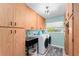 Bright laundry room features modern washer and dryer, lots of cabinets, and utility sink at 500 Tallahassee Ne Dr, St Petersburg, FL 33702