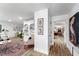 Bright and airy living room featuring hardwood floors, built-in shelving, and a view of the hallway at 500 Tallahassee Ne Dr, St Petersburg, FL 33702
