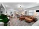 Open-concept living space with hardwood floors, comfortable seating, and dining area beyond at 500 Tallahassee Ne Dr, St Petersburg, FL 33702