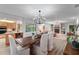Open-concept living room and dining room with fireplace and views of outdoor pool at 500 Tallahassee Ne Dr, St Petersburg, FL 33702