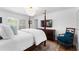 Bright main bedroom with shutters, wood floors, a shell chandelier, and tasteful furnishings at 500 Tallahassee Ne Dr, St Petersburg, FL 33702