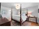 Bright main bedroom features a four poster bed, shuttered windows, and hardwood flooring at 500 Tallahassee Ne Dr, St Petersburg, FL 33702