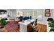 Well-lit home office with a large desk, plantation shutters, and a blue sofa for a comfortable workspace at 500 Tallahassee Ne Dr, St Petersburg, FL 33702
