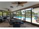 Covered patio with a table and chairs overlooking the pool and tropical landscaping at 500 Tallahassee Ne Dr, St Petersburg, FL 33702