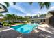 Sparkling pool surrounded by a brick patio, landscaping, and a well-maintained home exterior at 500 Tallahassee Ne Dr, St Petersburg, FL 33702