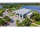 Aerial view of the clubhouse overlooking a scenic lake and green landscaping at 5609 Silver Sun Dr, Apollo Beach, FL 33572