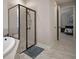 Bathroom with a framed glass shower, tiled floor, and a nearby doorway to the bedroom at 5609 Silver Sun Dr, Apollo Beach, FL 33572