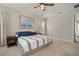 Cozy bedroom with neutral colors, a ceiling fan, and a picture window at 5609 Silver Sun Dr, Apollo Beach, FL 33572