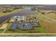 Aerial view of the tennis and basketball courts, pool, clubhouse, lake, and surrounding neighborhood at 5609 Silver Sun Dr, Apollo Beach, FL 33572