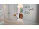 Hallway with multiple doors leading to rooms and decorated with shelves and decorative pieces at 5609 Silver Sun Dr, Apollo Beach, FL 33572