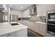 Bright kitchen with stainless steel appliances, a center island, and views of the entryway at 5609 Silver Sun Dr, Apollo Beach, FL 33572
