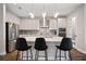 Gorgeous kitchen boasts a marble countertop, white cabinets, and stainless steel appliances at 5609 Silver Sun Dr, Apollo Beach, FL 33572