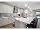 Modern kitchen featuring a stylish backsplash, sleek countertops and stainless steel appliances at 5609 Silver Sun Dr, Apollo Beach, FL 33572