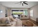 Comfortable living room with neutral tones, a large rug, and view to backyard at 5609 Silver Sun Dr, Apollo Beach, FL 33572