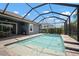 Inviting screened-in pool with brick surround, a fountain feature, and a covered patio for outdoor enjoyment at 5609 Silver Sun Dr, Apollo Beach, FL 33572