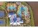 Aerial view of a resort-style pool with ample seating, palm trees, a lap pool, and a clubhouse at 5609 Silver Sun Dr, Apollo Beach, FL 33572