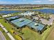 Aerial view of the community tennis and pickleball courts, pool, and surrounding neighborhood at 5609 Silver Sun Dr, Apollo Beach, FL 33572