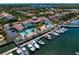 Community aerial view featuring a pool, clubhouse, and marina with boats docked at 5823 Bowen Daniel Dr # 606, Tampa, FL 33616