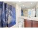 Bathroom featuring a vanity sink, toilet, and a shower/tub with a space-themed shower curtain at 5823 Bowen Daniel Dr # 606, Tampa, FL 33616