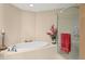 Well-lit bathroom with bathtub and glass shower, and neutral wall colors at 5823 Bowen Daniel Dr # 606, Tampa, FL 33616