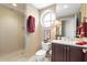 Bathroom features a glass-enclosed shower, round window, and dark wood vanity at 5823 Bowen Daniel Dr # 606, Tampa, FL 33616
