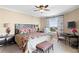 Comfortable bedroom with large bed, ceiling fan, an accent chair and a view of the city at 5823 Bowen Daniel Dr # 606, Tampa, FL 33616