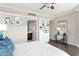 Bright bedroom with hardwood floors and built-in shelves featuring a glimpse into the bathroom at 5823 Bowen Daniel Dr # 606, Tampa, FL 33616