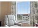 Comfortable accent chair, view of the city buildings and harbor with boats and designer curtains at 5823 Bowen Daniel Dr # 606, Tampa, FL 33616