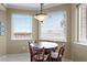 Cozy breakfast nook featuring a round table, four chairs, a hanging pendant light, and bright natural light at 5823 Bowen Daniel Dr # 606, Tampa, FL 33616