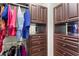 Well-organized walk-in closet with custom wood shelving and hanging rods for ample storage at 5823 Bowen Daniel Dr # 606, Tampa, FL 33616
