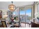 View of dining room with chandelier and access to the balcony overlooking the water at 5823 Bowen Daniel Dr # 606, Tampa, FL 33616