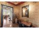 Inviting entryway with beautiful wallpaper, hardwood floors, and an antique mirror at 5823 Bowen Daniel Dr # 606, Tampa, FL 33616