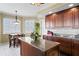 Charming kitchen features granite counters, wood cabinets, and a center island with bar stool seating at 5823 Bowen Daniel Dr # 606, Tampa, FL 33616