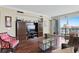 Comfortable living room with custom built-ins, hardwood floors, and a view of the water at 5823 Bowen Daniel Dr # 606, Tampa, FL 33616