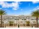 View of a well-maintained marina with an array of boats, framed by palm trees and blue skies at 5823 Bowen Daniel Dr # 606, Tampa, FL 33616