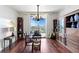 Bright office space features hardwood floors, a stylish chandelier, and views from the sliding glass doors at 5823 Bowen Daniel Dr # 606, Tampa, FL 33616